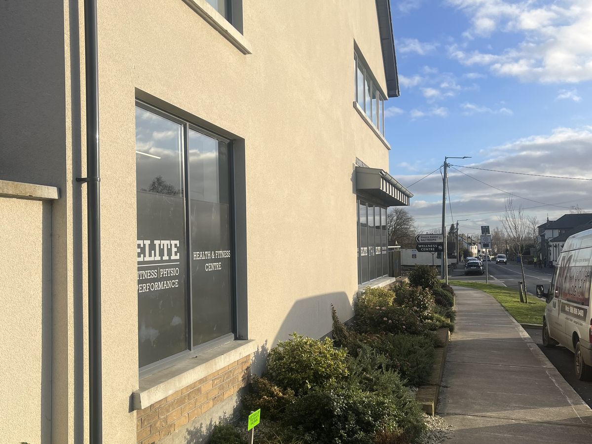 The Elite building from the footpath, window decal reading Health and Fitness Centre